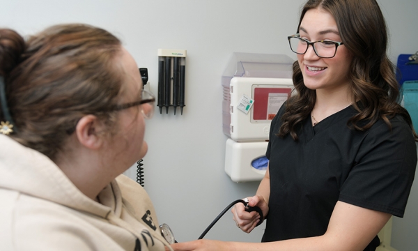 EKU pre-med student checks patient's blood pressure 