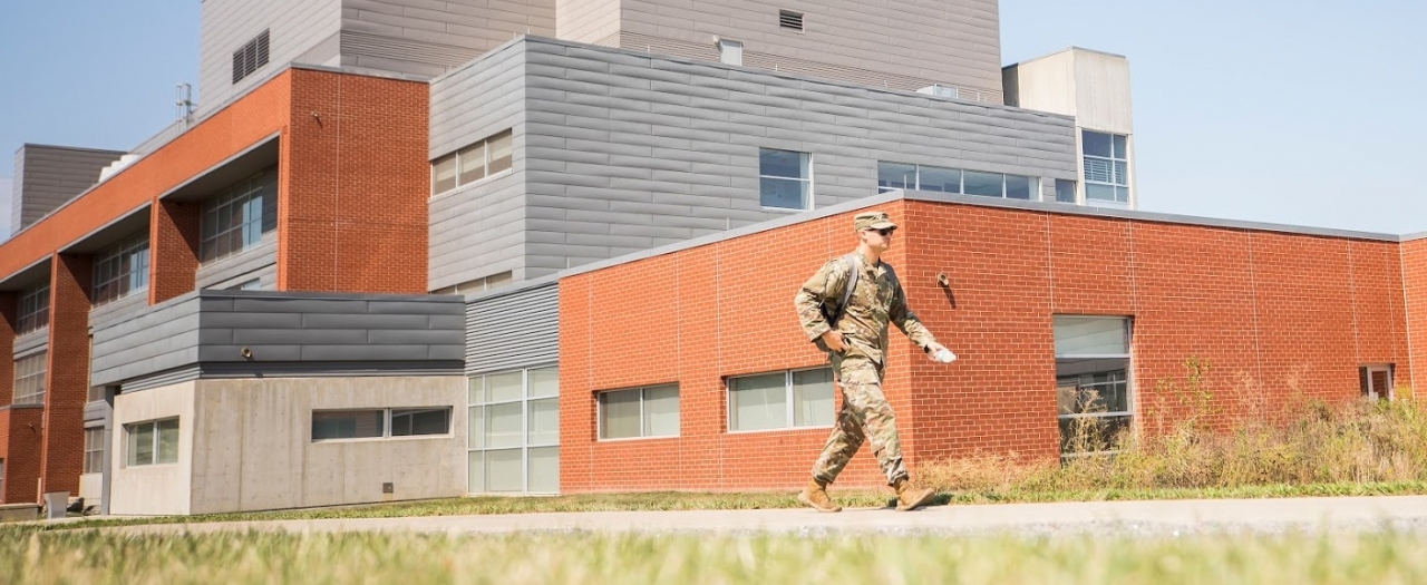 military member walking by the New Science building in uniform