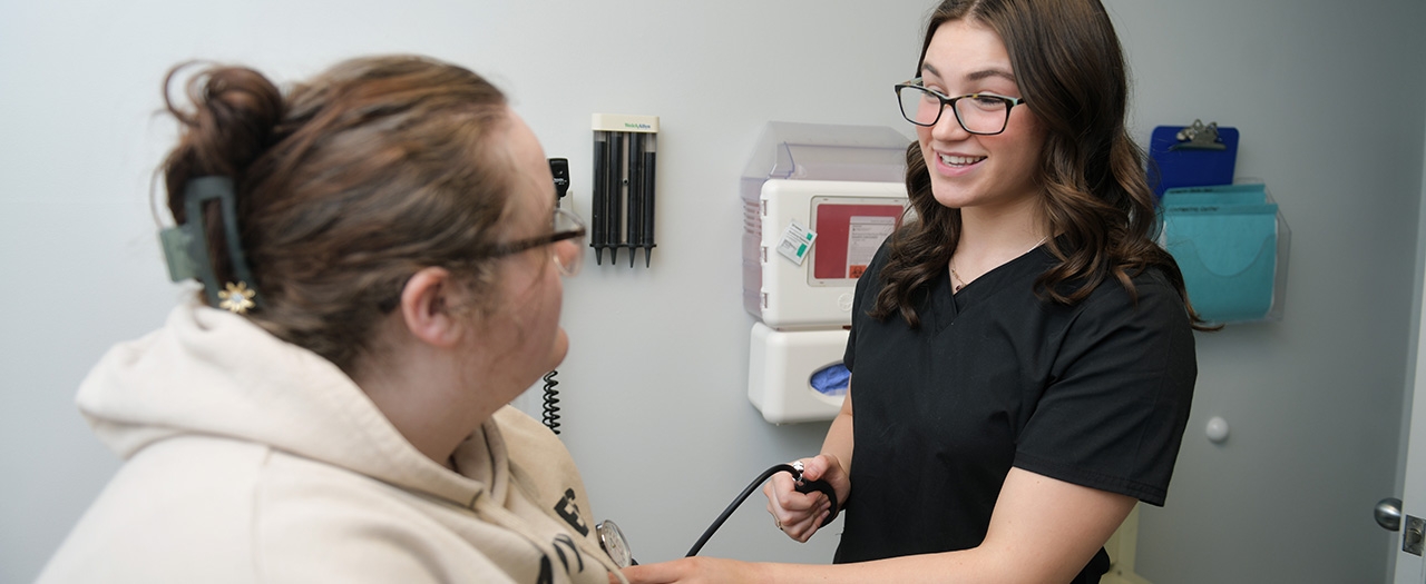 EKU pre-med student checks patient's blood pressure 