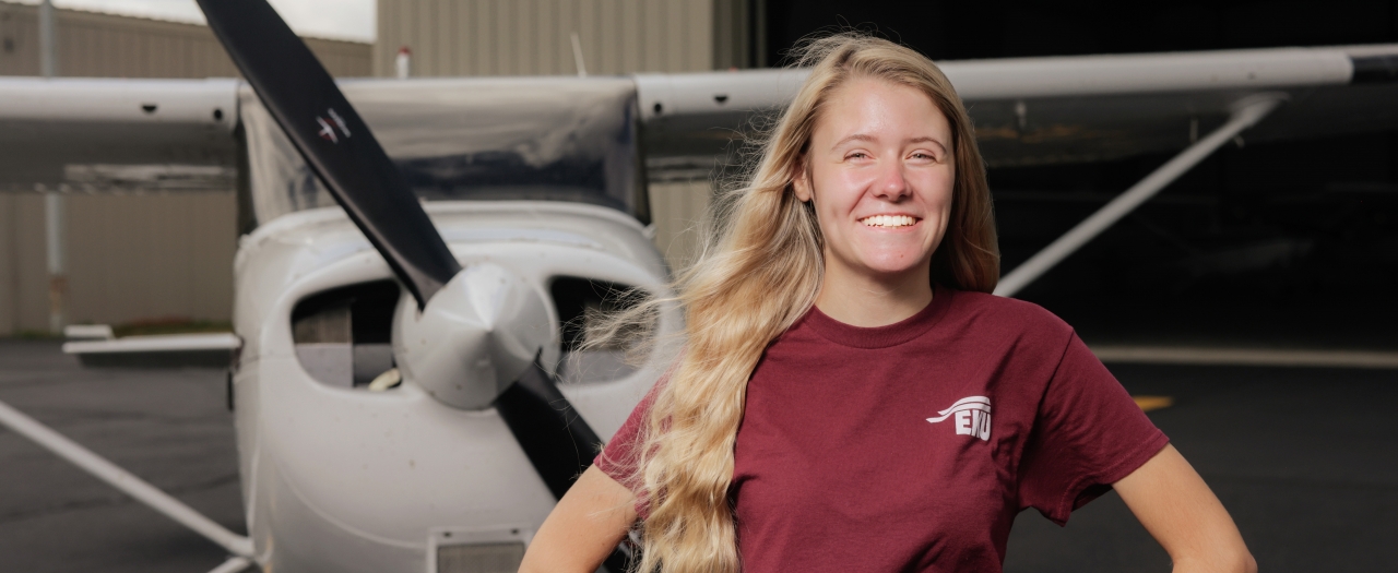 Lily Norman stands in front of aircraft at Central Kentucky Regional Airport.