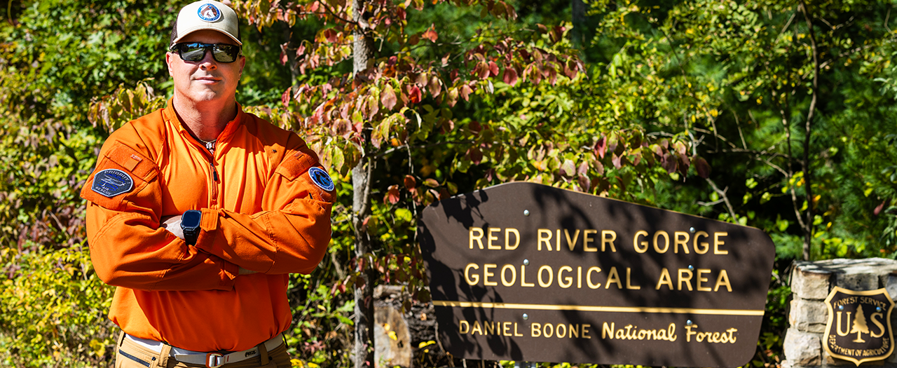 John May in front of the Red River Gorge sign in Daniel Boone National Forest