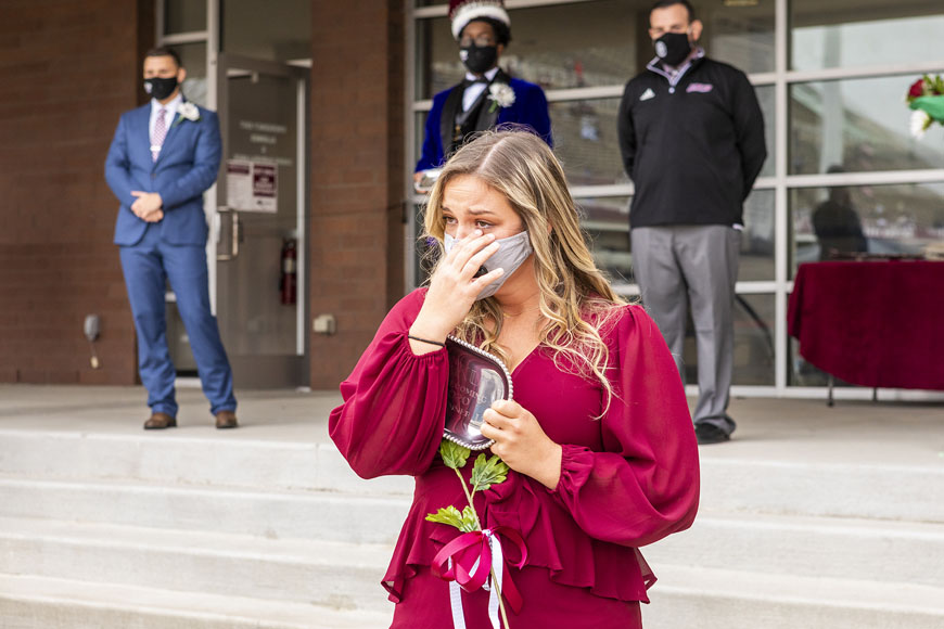 Homecoming runner up wiping away tears after watching a video from her dad